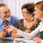 Senior couple meeting with agent or advisor